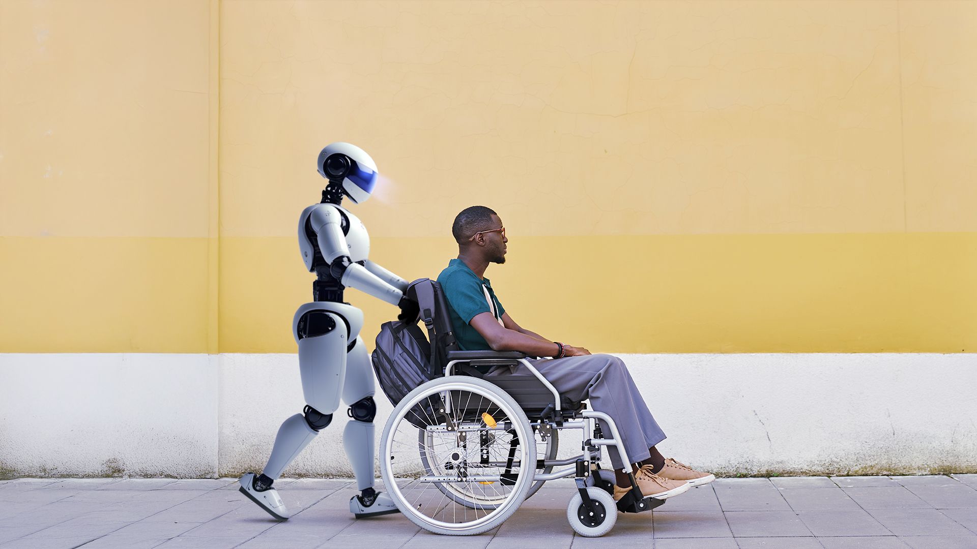 A robot pushing a person in a wheelchair.
