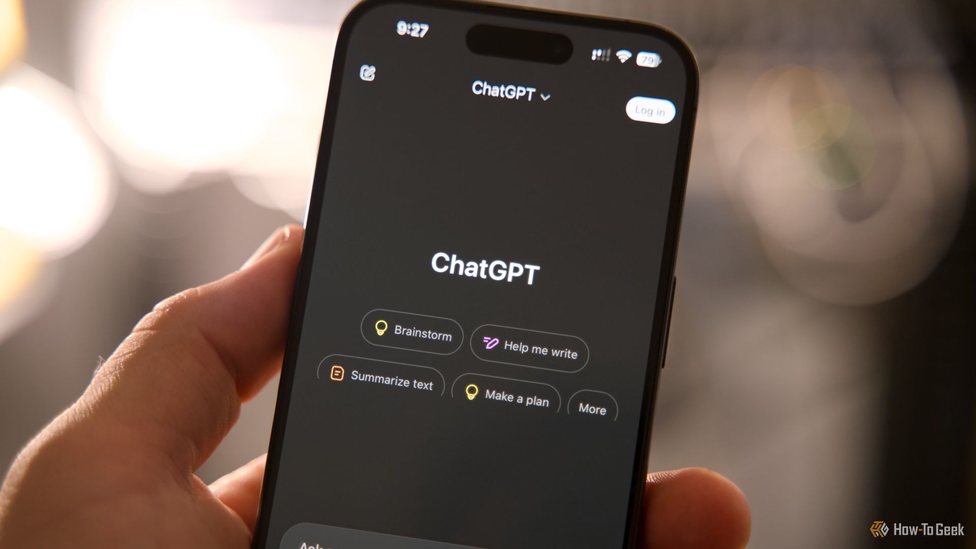 The main page of ChatGPT on an iPhone being held in a hand.