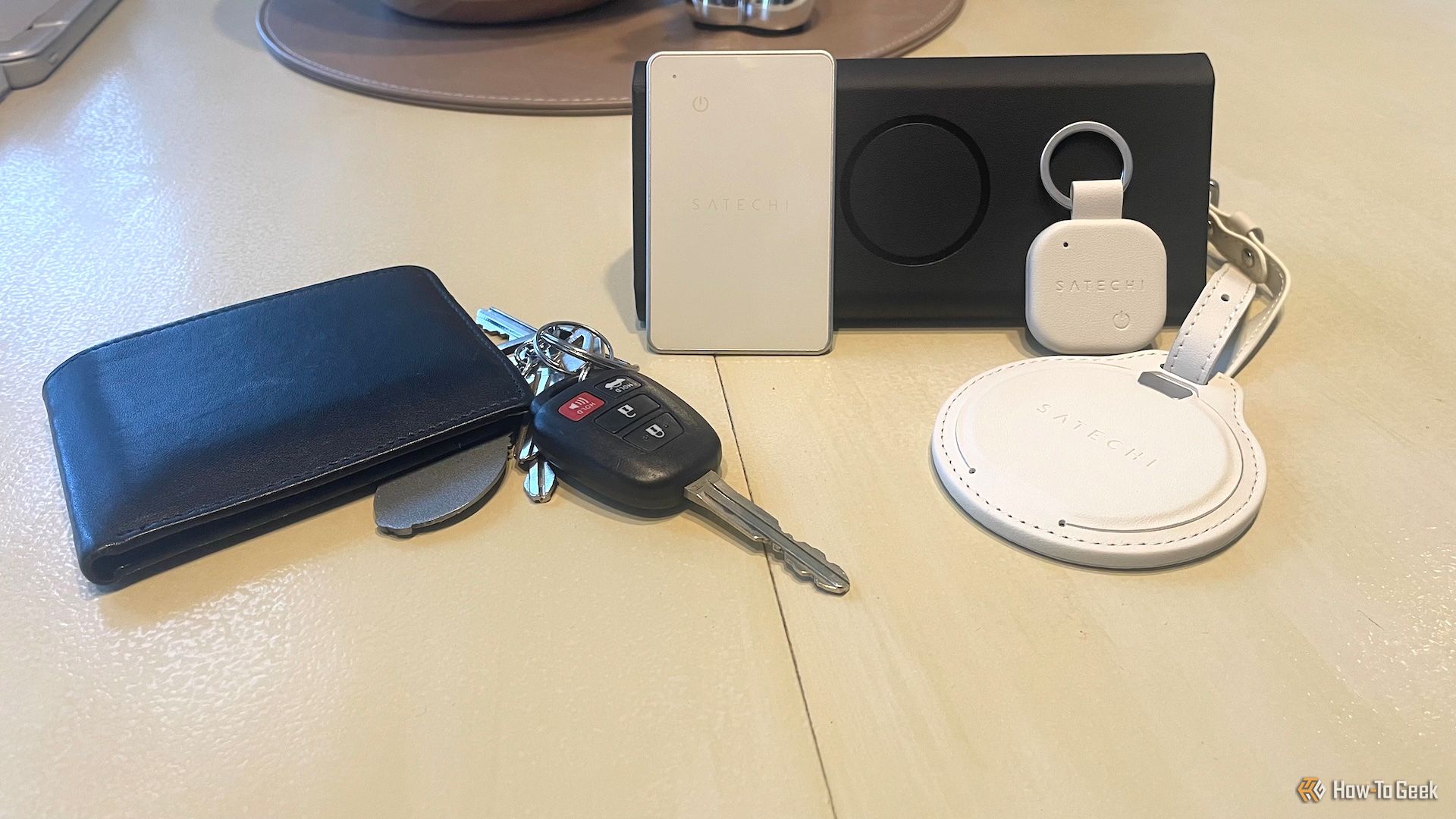 The Satech FindAll Collection placed next to a wallet and set of keys.