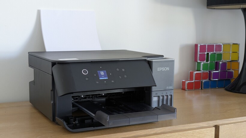 Photo de style de vie de l'imprimante chargée de papier, avec un jouet de bureau coloré en arrière-plan