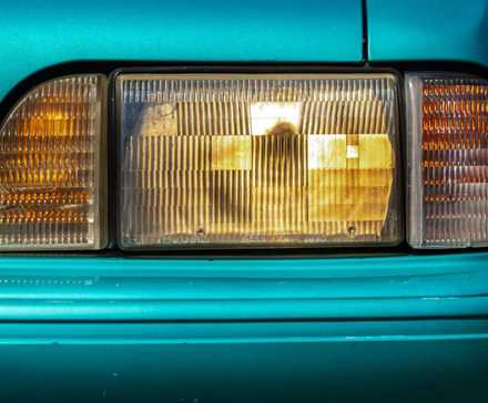 Gros plan du phare d'une Ford Mustang LX 5.0 bleue de 1993.